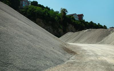 Stockpiles of fine grey crushed stone at a quarry — stock photo