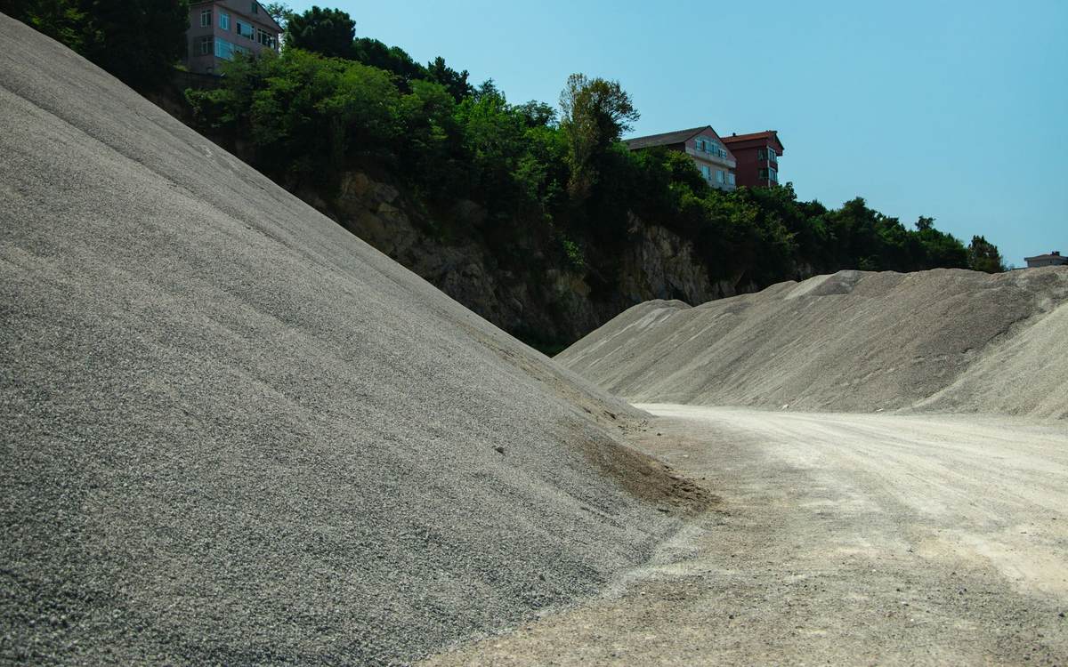 Stockpiles of fine grey crushed stone at a quarry — stock photo