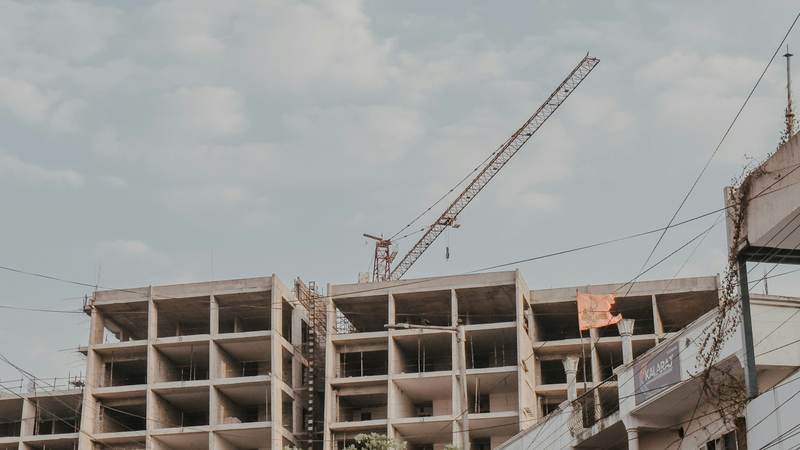 Concrete frame of a building under construction with a tower crane