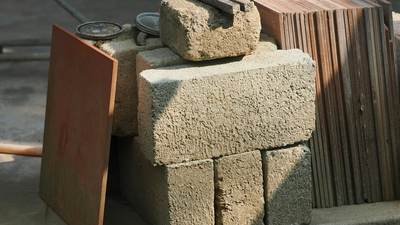 Stack of concrete blocks next to wooden planks