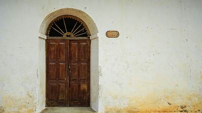 Wooden double door in an arched doorway
