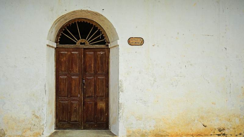 Wooden double door in an arched doorway